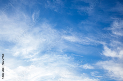 blue sky with Cirrostratus clouds from below, overhead diagonally in sky with sunlight. Bottom view. Meteorology and Climate Concept Background  © ImageSine