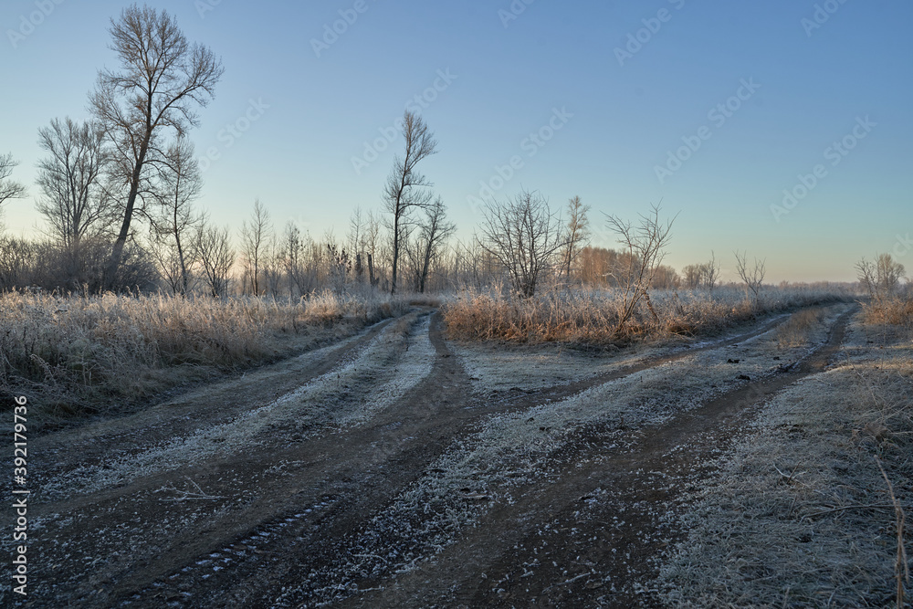 Breath of winter, first ice on the lake, dawn on a frosty morning with frost on the grass, close-up of frost, patterns on the first ice. Breath of winter, first ice on the lake, dawn on a frosty morning with frost on the grass, close-up of frost, patterns on the first ice.