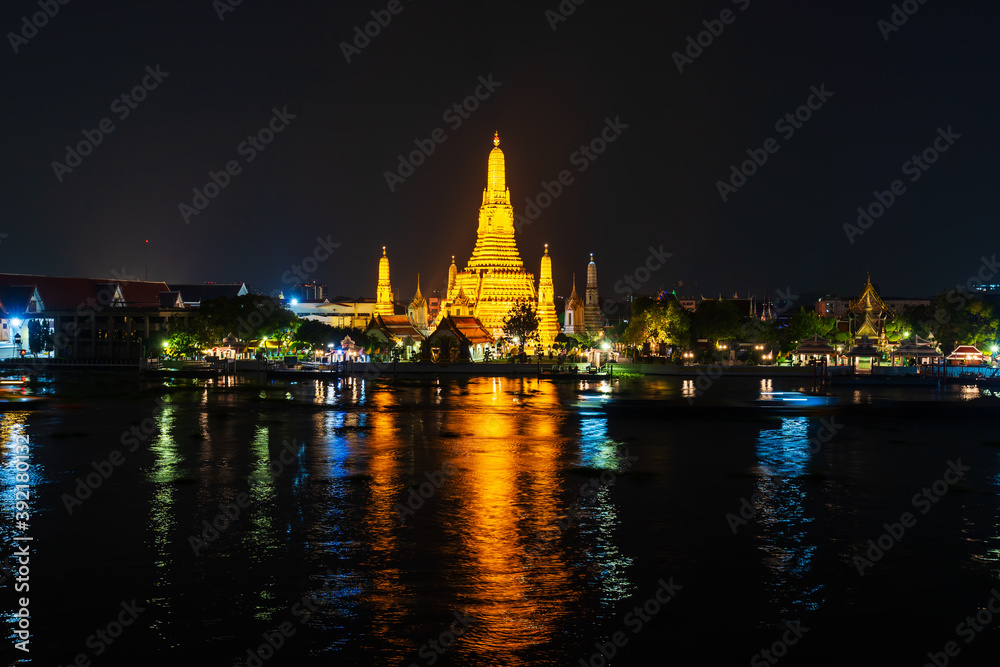 Wat Arun with Chao Phraya river at night in Bangkok, Thailand