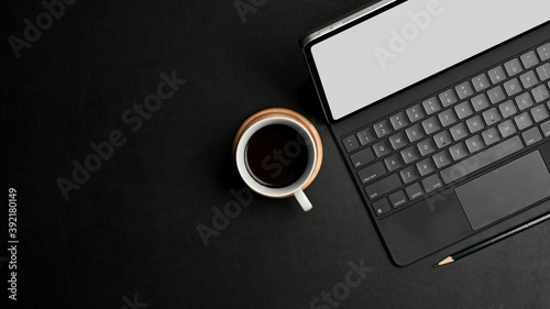 Black concept workspace digital tablet, keyboard, coffee cup and copy space, clipping path