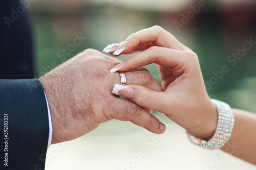 Hands of groom and bride at wedding day. Bridal couple hugging. Wedding love and family concept close up macro photo with selective focus © VolkovaElena