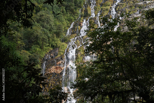 Beautiful waterfall on the way trekking to Annapurna base camp - green natural scene at annapurna national park Nepal