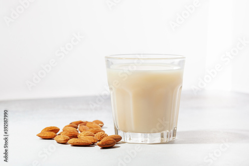 Vegan dairy free almond milk in bottle on gray background
