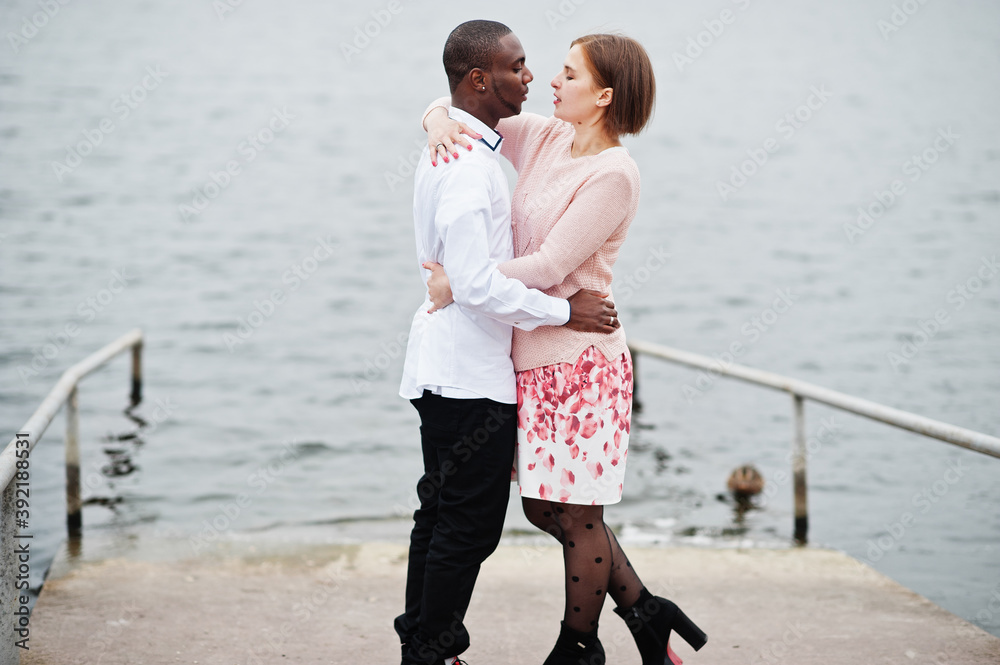 Fototapeta premium Happy multiethnic couple in love story. Relationships of african man and white european woman.