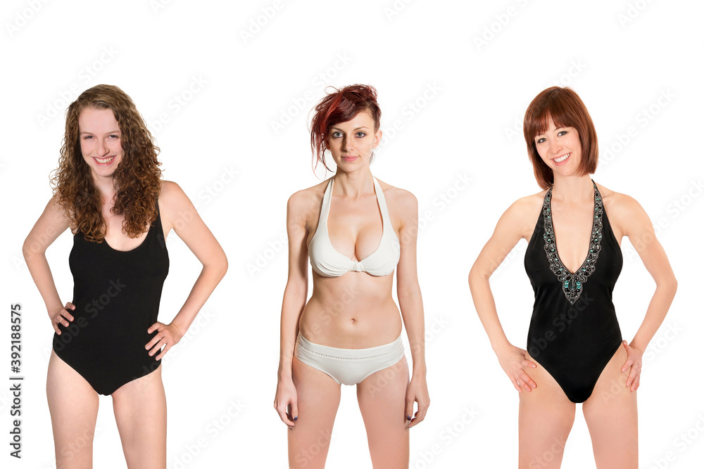 Portraits of three attractive models wearing white and black swimwear, isolated on neutral studio background Portraits of three attractive models wearing white and black swimwear, isolated on neutral studio background