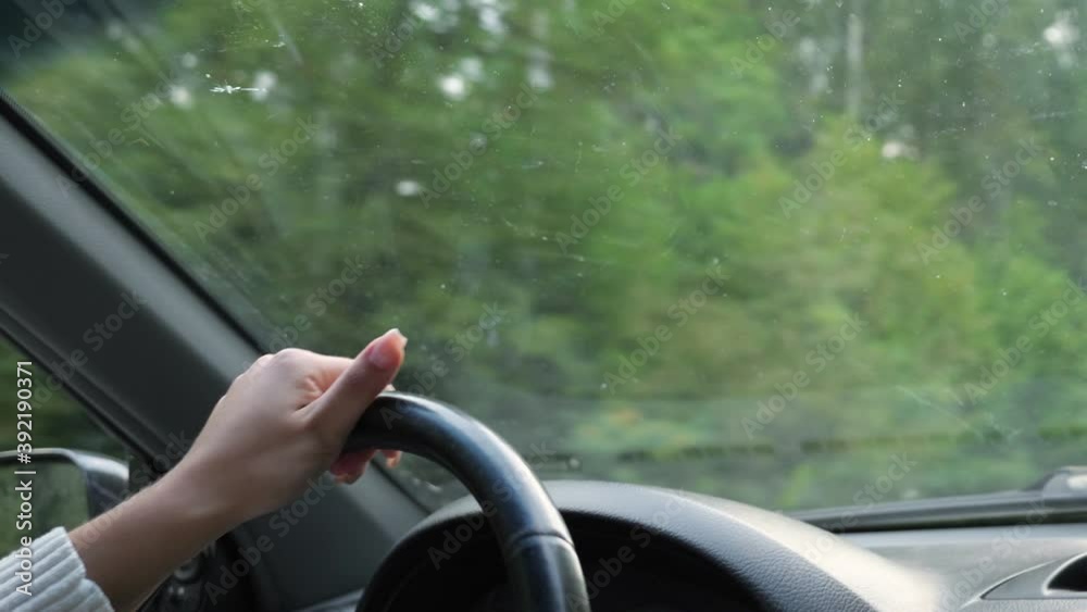 Close-up of female hands on the steering wheel of a driving car. Close-up of female hands on the steering wheel of a driving car.