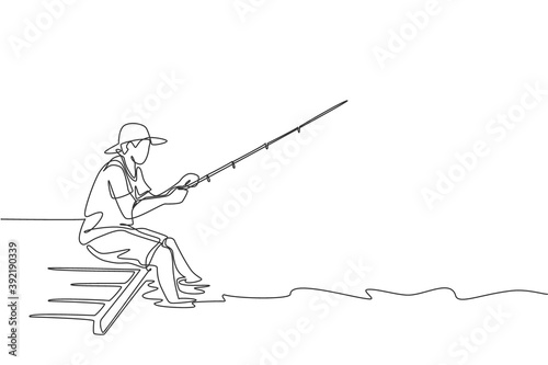 One single line drawing young happy fisher man siting on wooden pier and fishing peacefully vector graphic illustration. Holiday traveling for fishing hobby concept. Modern continuous line draw design