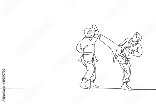 Single continuous line drawing two young confident karateka men in kimono practicing karate combat at dojo. Martial art sport training concept. Trendy one line draw design vector graphic illustration