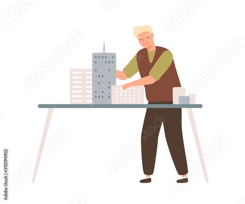 Young male architect install mini city building models on table. Professional engineer or designer working with project of town. Flat vector cartoon illustration isolated on white background
