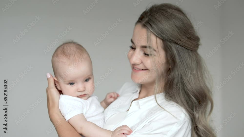 Young woman eventually become happy, holding recently adopted darling child Young woman eventually become happy, holding recently adopted darling child