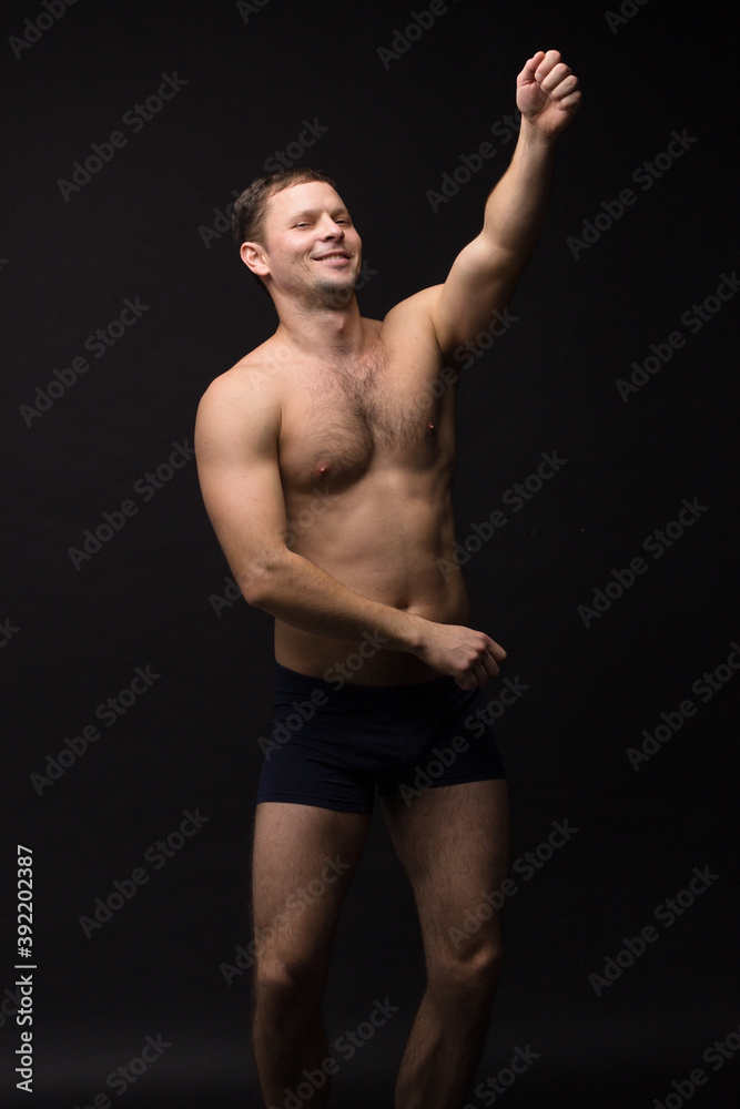 Fototapeta premium Handsome man in underwear on the black background. Muscular and athletic. Underwear man portrait. Male underwear model in studio