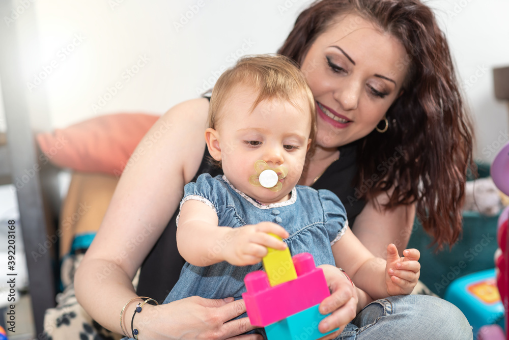 Mother playing with her baby girl