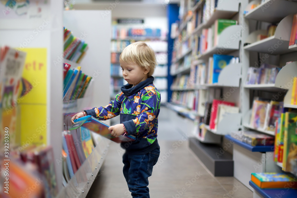 Adorable little boy, sitting in a book store