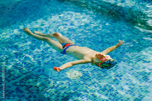 Slika na platnu Toddler swimming training in the pool