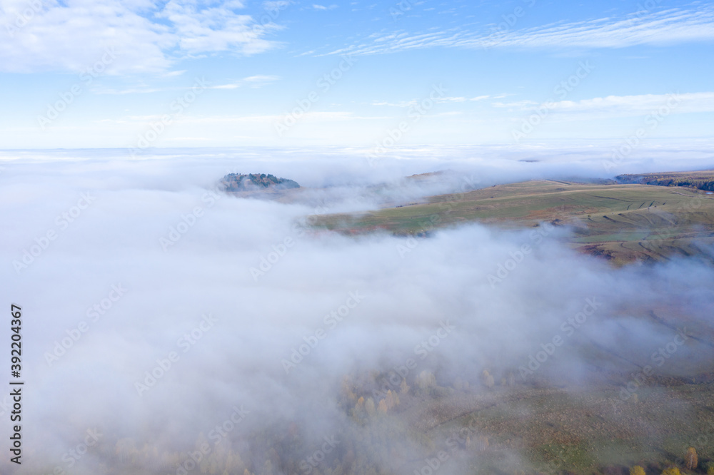 Aerial drone shot of flying above clouds