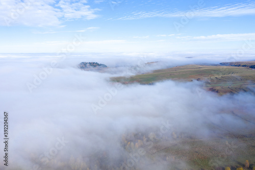 Aerial drone shot of flying above clouds © salajean