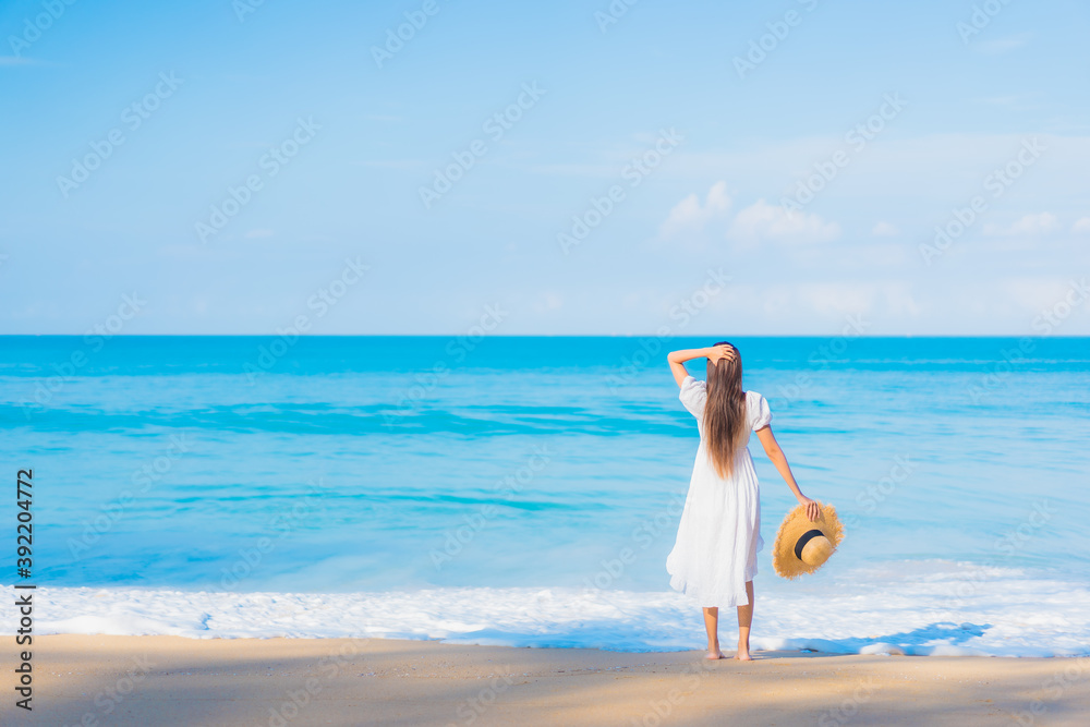 Portrait beautiful young asian woman relax smile leisure around sea beach ocean