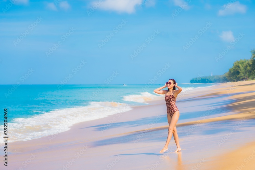 Portrait beautiful young asian woman relax smile leisure around sea beach ocean