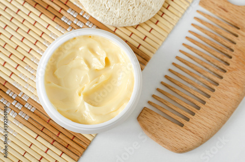 Fotografia Yellow facial mask (banana face cream, shea butter hair mask, body butter) in the small white container