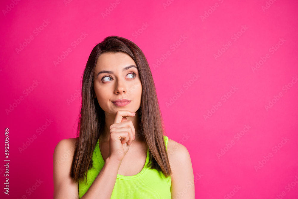 Photo of lovely minded lady finger chin look up empty space wear green top isolated bright pink color background Photo of lovely minded lady finger chin look up empty space wear green top isolated bright pink color background