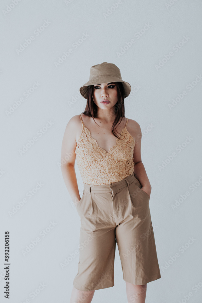 Beautiful fashionable oriental woman brunette in fashionable light clothes Beautiful fashionable oriental woman brunette in fashionable light clothes