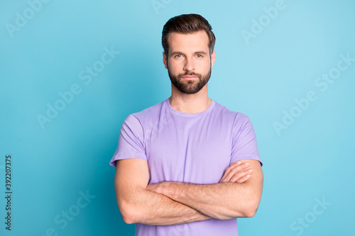 Photo of young attractive handsome man crossed hands confident smart isolated over blue color background