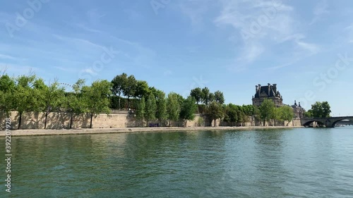 Footage of Seine river and famous international art museum's building in Paris. It is a sunny summer day. Camera moves forward. photo