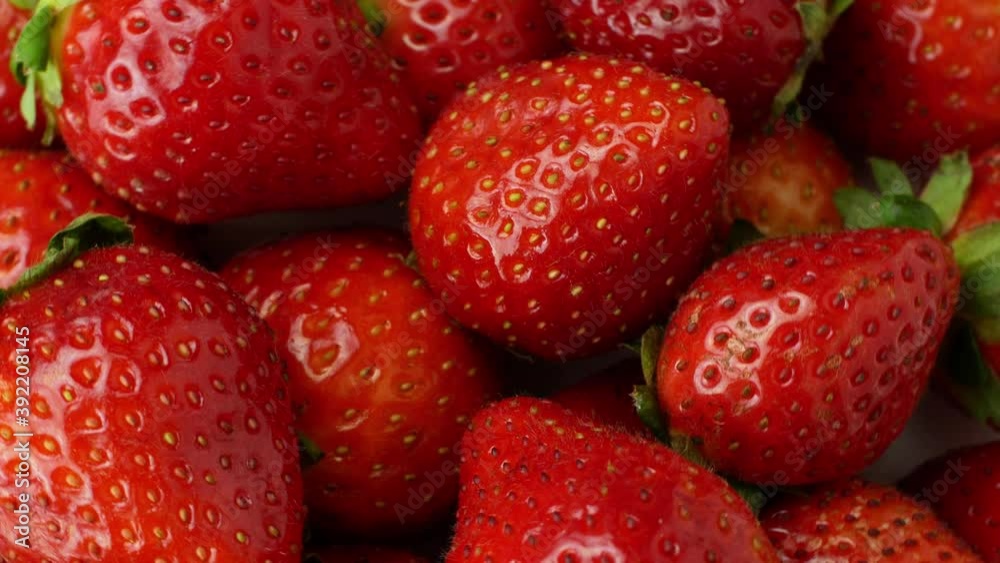 Juicy ripe exotic strawberry rotates on a white background 360. Eco fruits and berries summer. Juicy ripe exotic strawberry rotates on a white background 360. Eco fruits and berries summer.