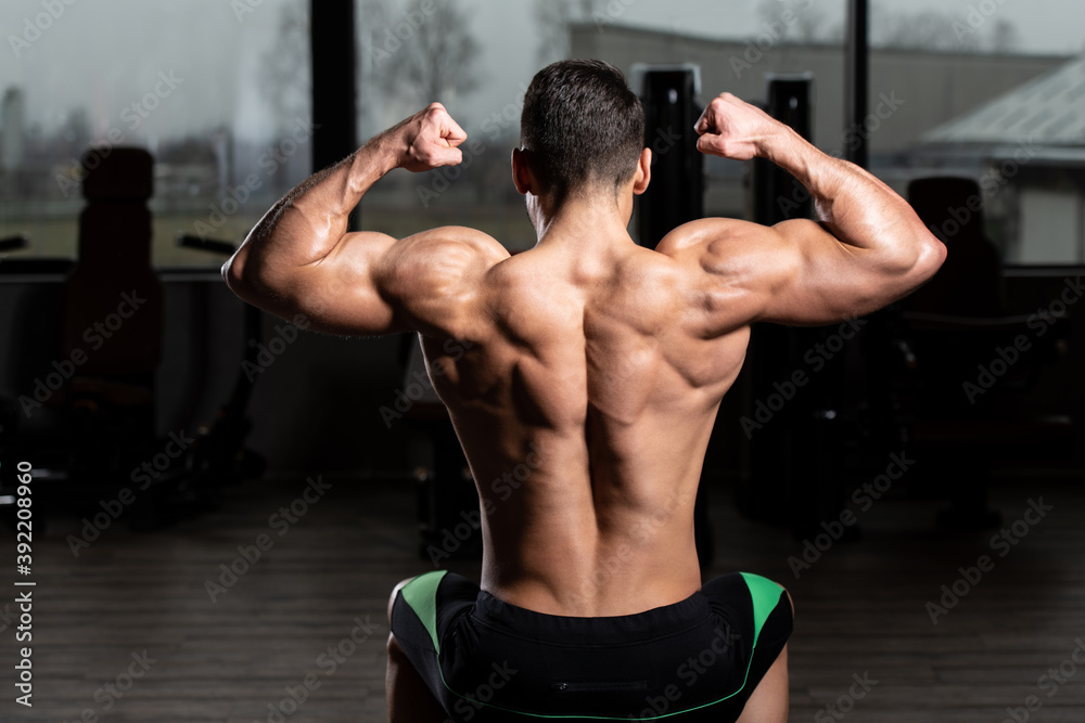 Muscular Men is Hitting Back Double Bicep Pose Muscular Men is Hitting Back Double Bicep Pose