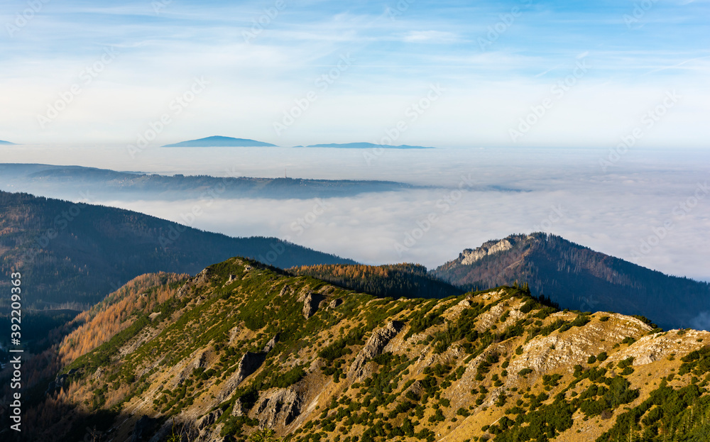 The phenomenon of inversion visible from the Tatra Mountains. Above the clouds you can see Gubalowka (a mountain in the Gubalowka Range) and Babia Gora (Babia hora) in Zywiec Beskids. Poland.