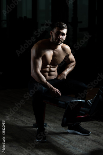 Muscular Man After Exercise Resting In Gym