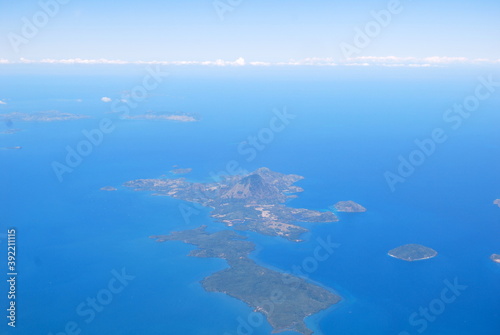 Panoramic view of our blue planet from the plane and islands in the ocean make infinity effect with sky