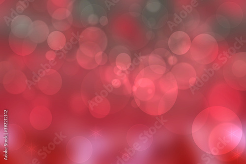 A festive abstract red Happy New Year or Christmas texture background and with color blurred bokeh lights and stars. Space for design. Card concept or advertising.