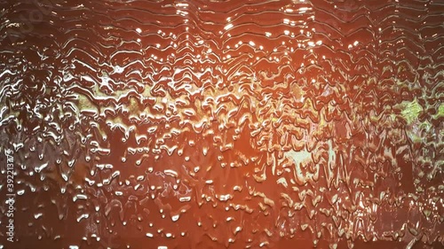 Liquid milk hot chocolate flowing down on wall