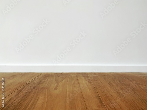 Teak wood floor and white walls. Interior and background concept. © Attakorn