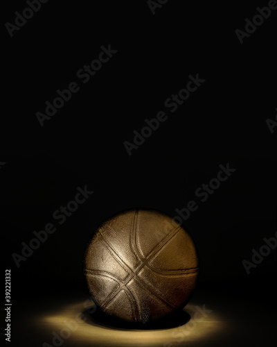 Golden basketball ball on the parquet with black background