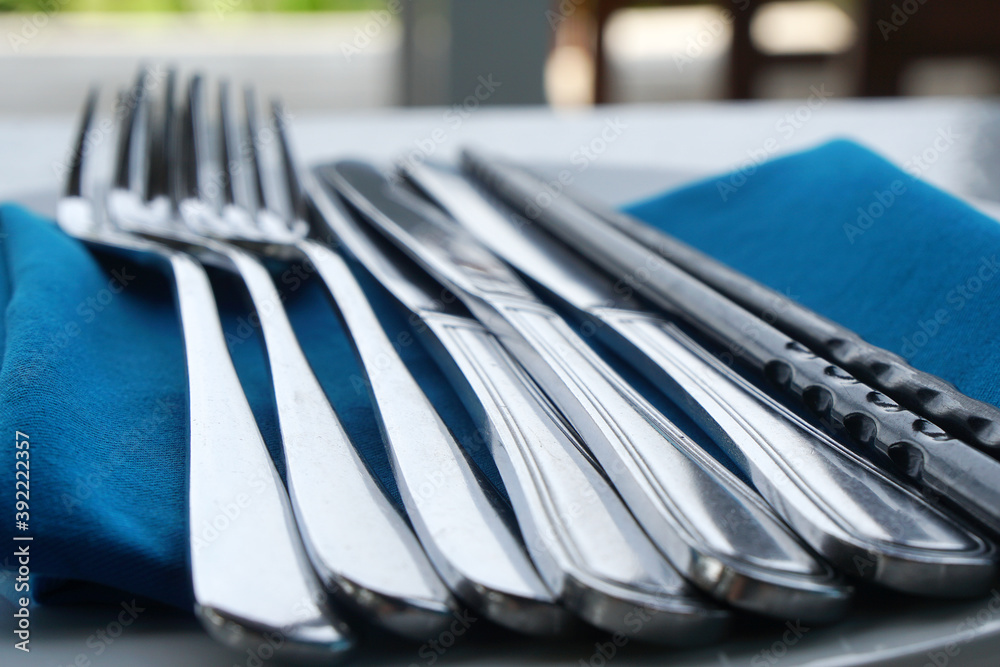 Plates and cutlery or silverware , flatware on the table Plates and cutlery or silverware , flatware on the table