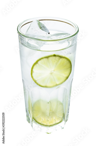 highball glass with prepared gin and tonic cocktail on the rock with two slices of lime isolated on white background