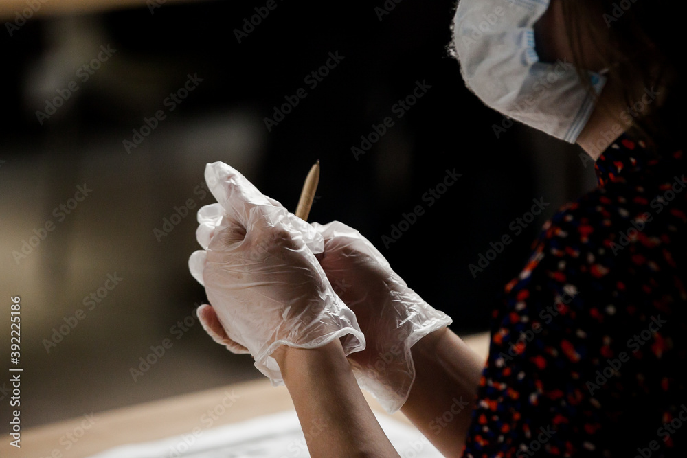 a man with gloves holding a pen, isolated work, protective equipment a man with gloves holding a pen, isolated work, protective equipment