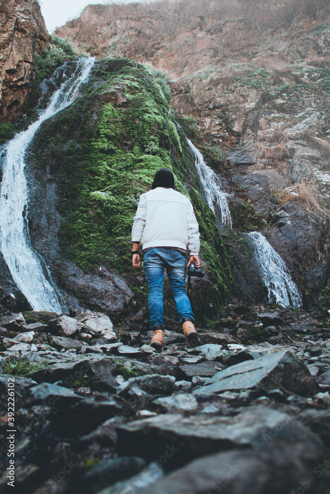 man and waterfall (green)