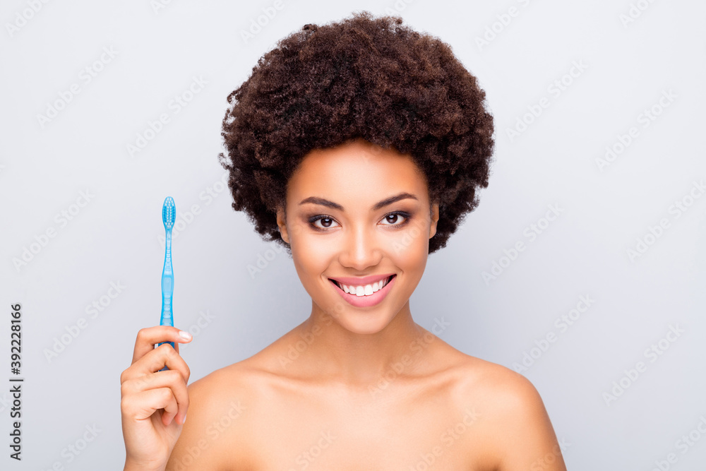 Close-up portrait of her she nice attractive cheerful wavy-haired girl holding in hand using new electric toothbrush advert ad caries treatment isolated on light white gray color pastel background Close-up portrait of her she nice attractive cheerful wavy-haired girl holding in hand using new electric toothbrush advert ad caries treatment isolated on light white gray color pastel background
