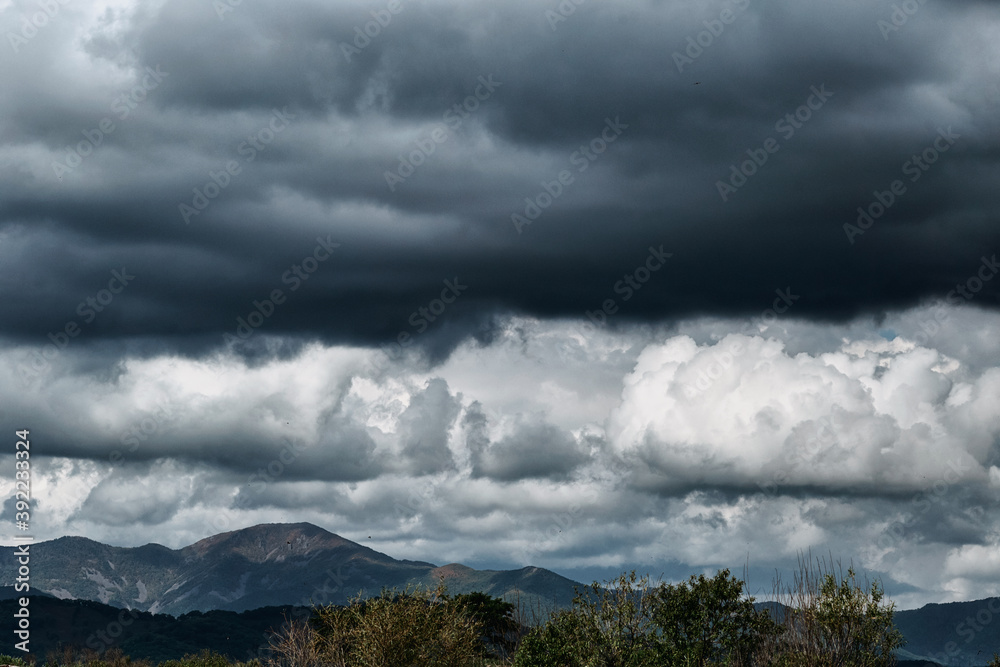 Gloomy coudy sky and dark mountains. Stormy weather and rainy clouds.