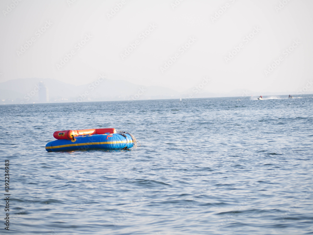 Fototapeta premium A rubber boat floating in the sea