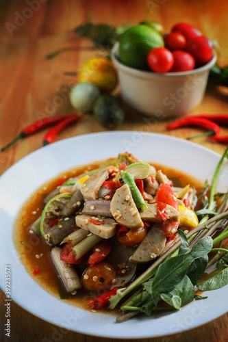 Thai spicy lotus stem salad with Vietnamese pork sausage. Northeast Thai cuisine. Thai street food style