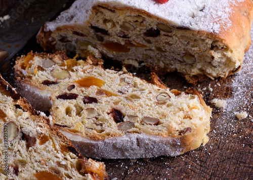 Stollen, a traditional European cake with nuts and candied fruit, is dusted with icing sugar