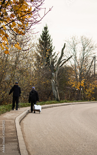 Old people walk along the road