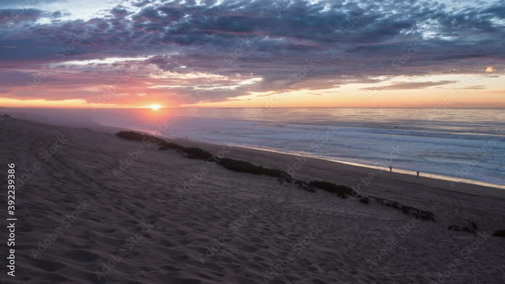 Beautiful colors of sunrise sky with red golden clouds over ocean beach in peaceful evening New Zealand nature landscape Time lapse Beautiful colors of sunrise sky with red golden clouds over ocean beach in peaceful evening New Zealand nature landscape Time lapse