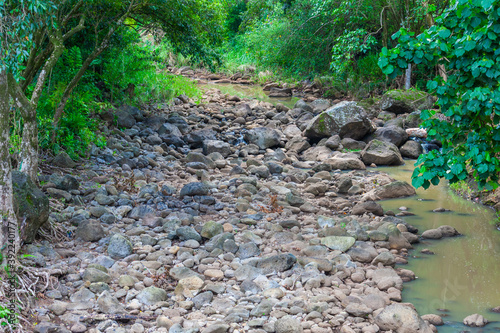 Dry, rocky riverbed, Waimea Valley, Oahu, Hawaii. Only remnants of water during dry season. photo