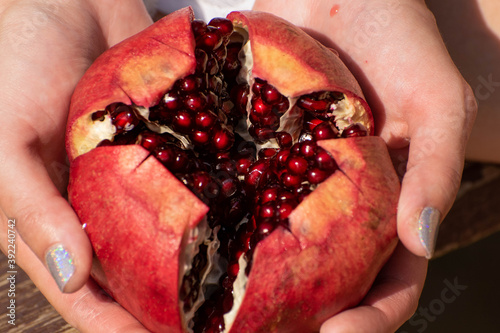 juicy open pomegranate in hands