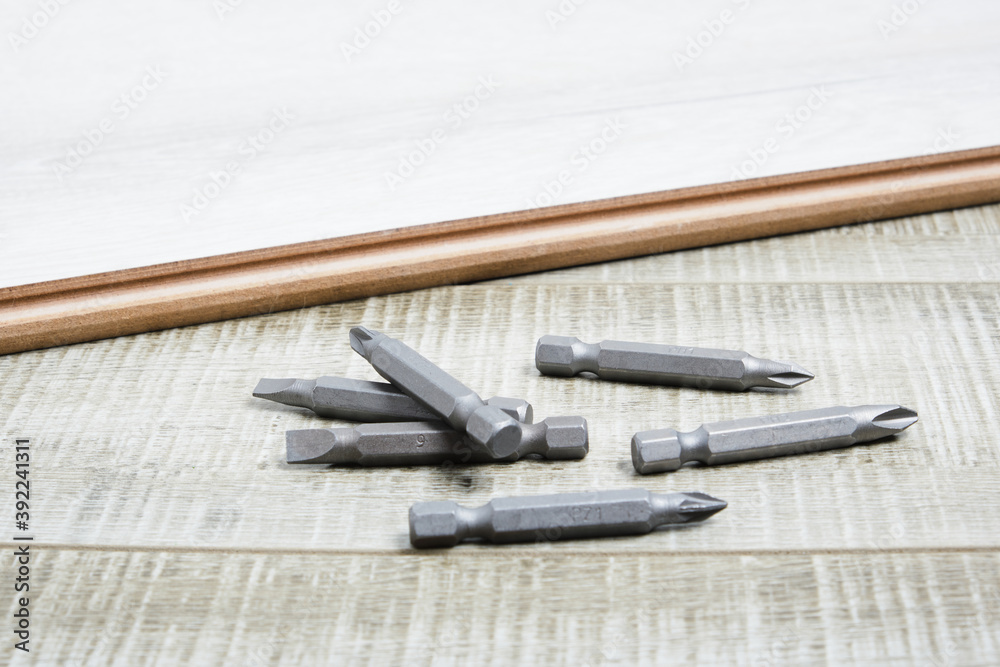 Set of metal bits for screwdriver on wooden background copy space Set of metal bits for screwdriver on wooden background copy space